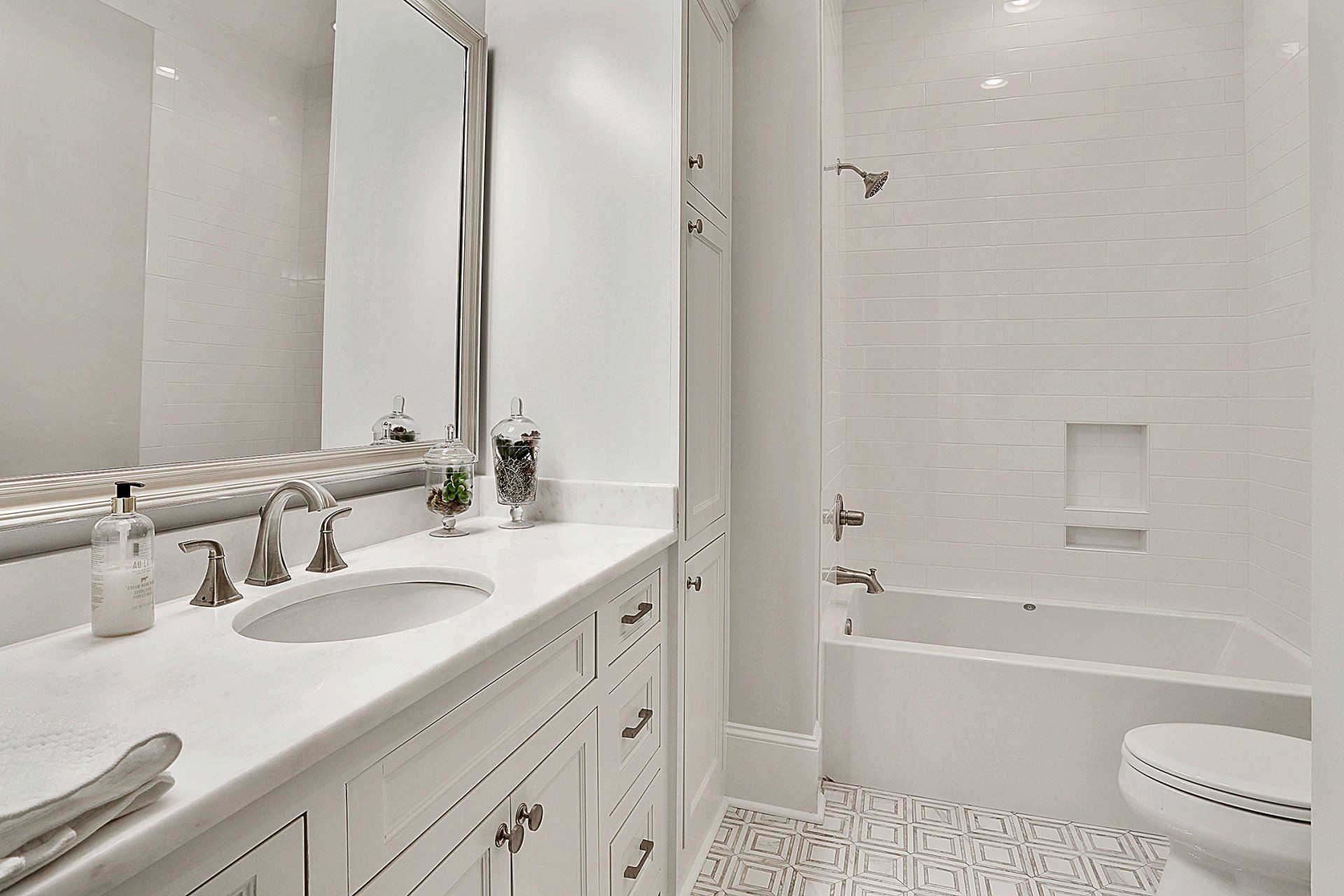 white bathroom with silver finishes