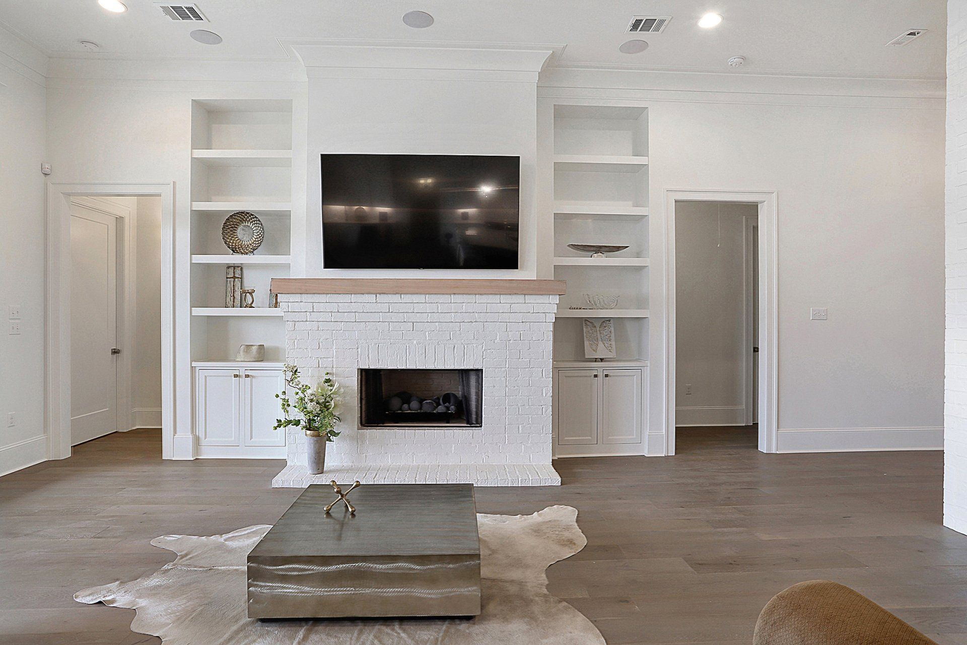 white fireplace with wood mantle