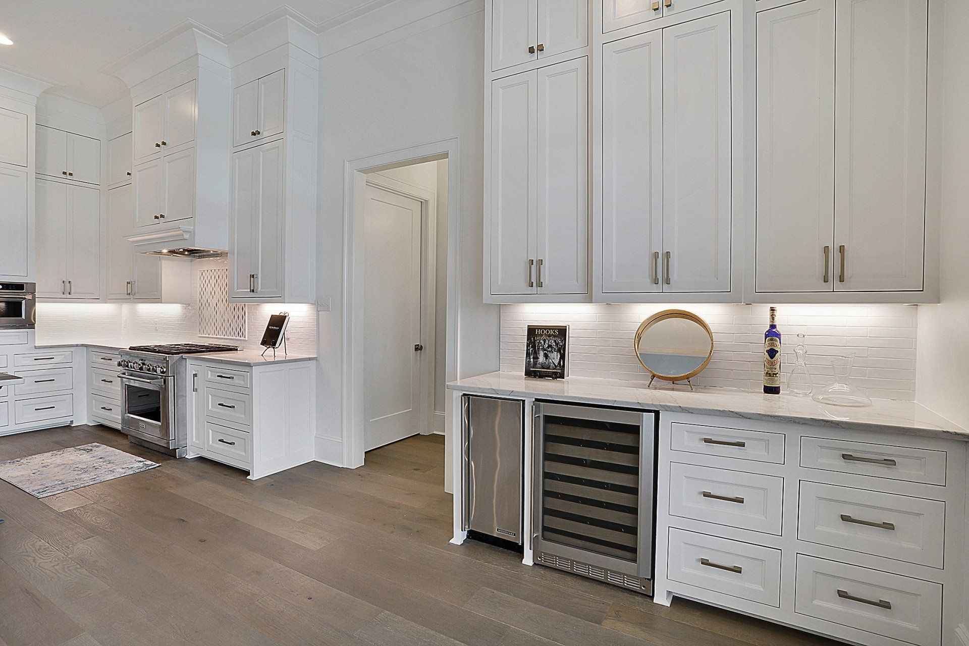 white kitchen with wine fridge reno