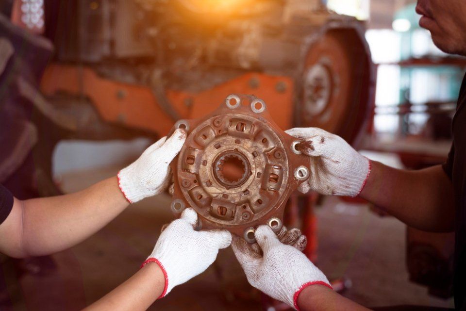 mechanic checking a metal part