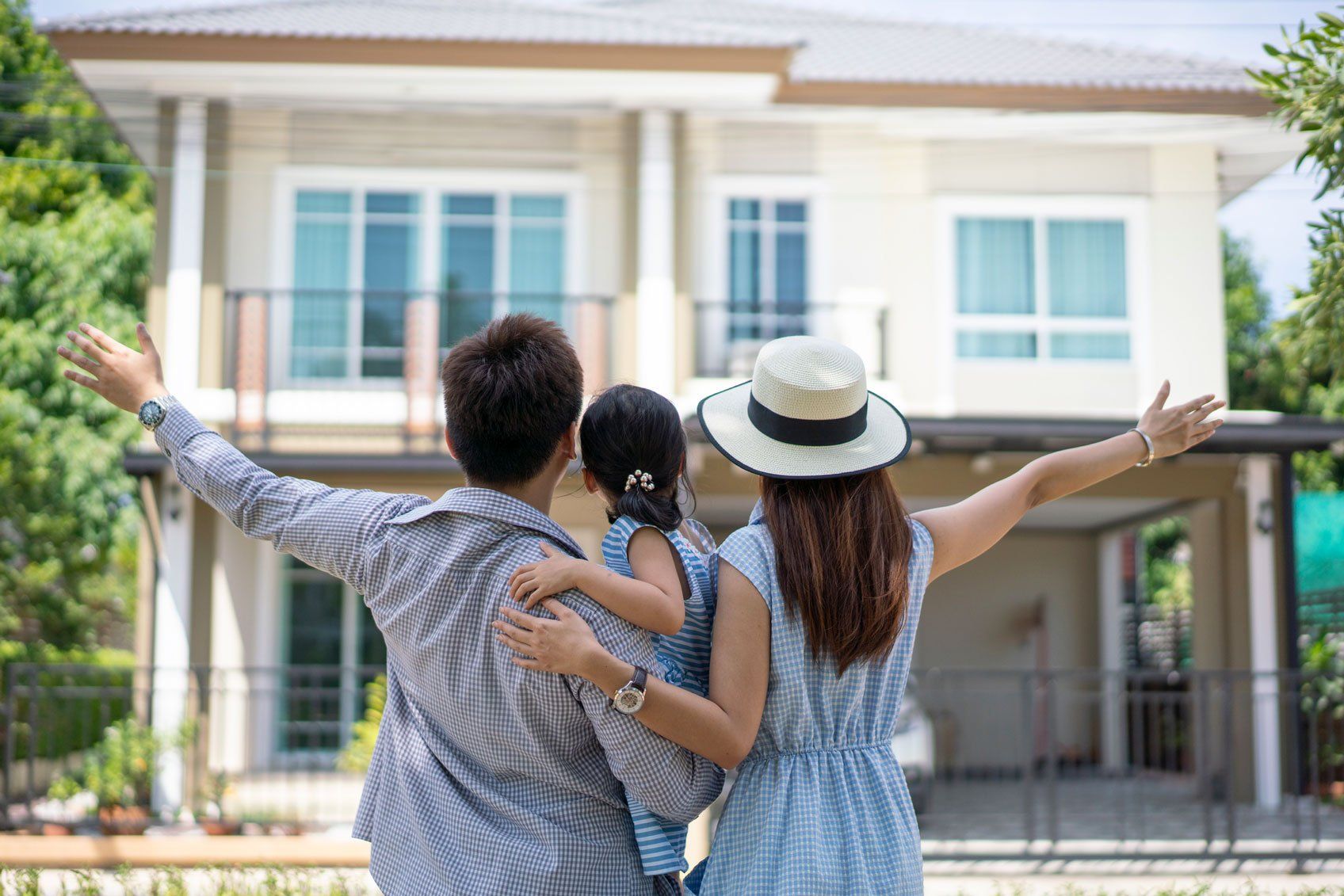 Family in front of their new home — Lenexa, KS — National Home Buyer’s Alliance