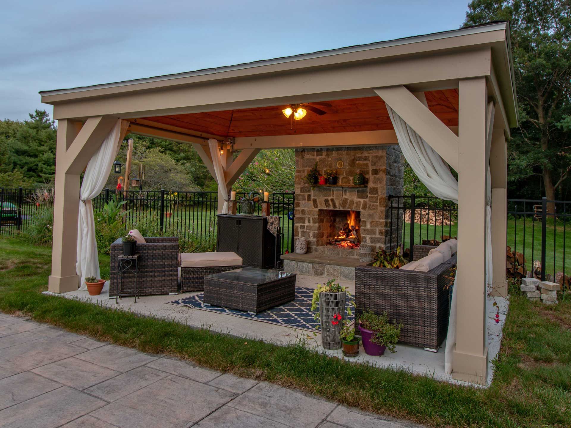 Covered patio with stone outdoor fireplace.