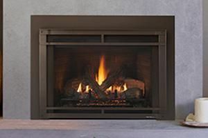 Gas fireplace with burning flames and decorative logs, set in a brown metallic frame. Gas fireplace with burning flames and decorative logs, set in a brown metallic frame.