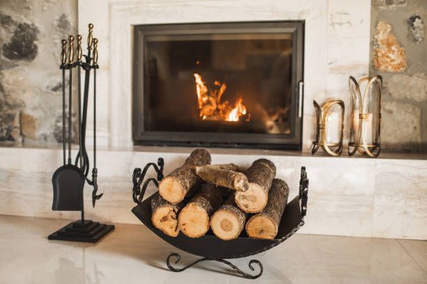 Fireplace with burning fire, logs, and fireplace tools.