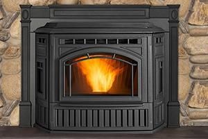 Black pellet stove with flames burning brightly, set in a stone hearth. Black pellet stove with flames burning brightly, set in a stone hearth.