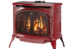 Red gas stove with burning flames behind a glass door. Red gas stove with burning flames behind a glass door.
