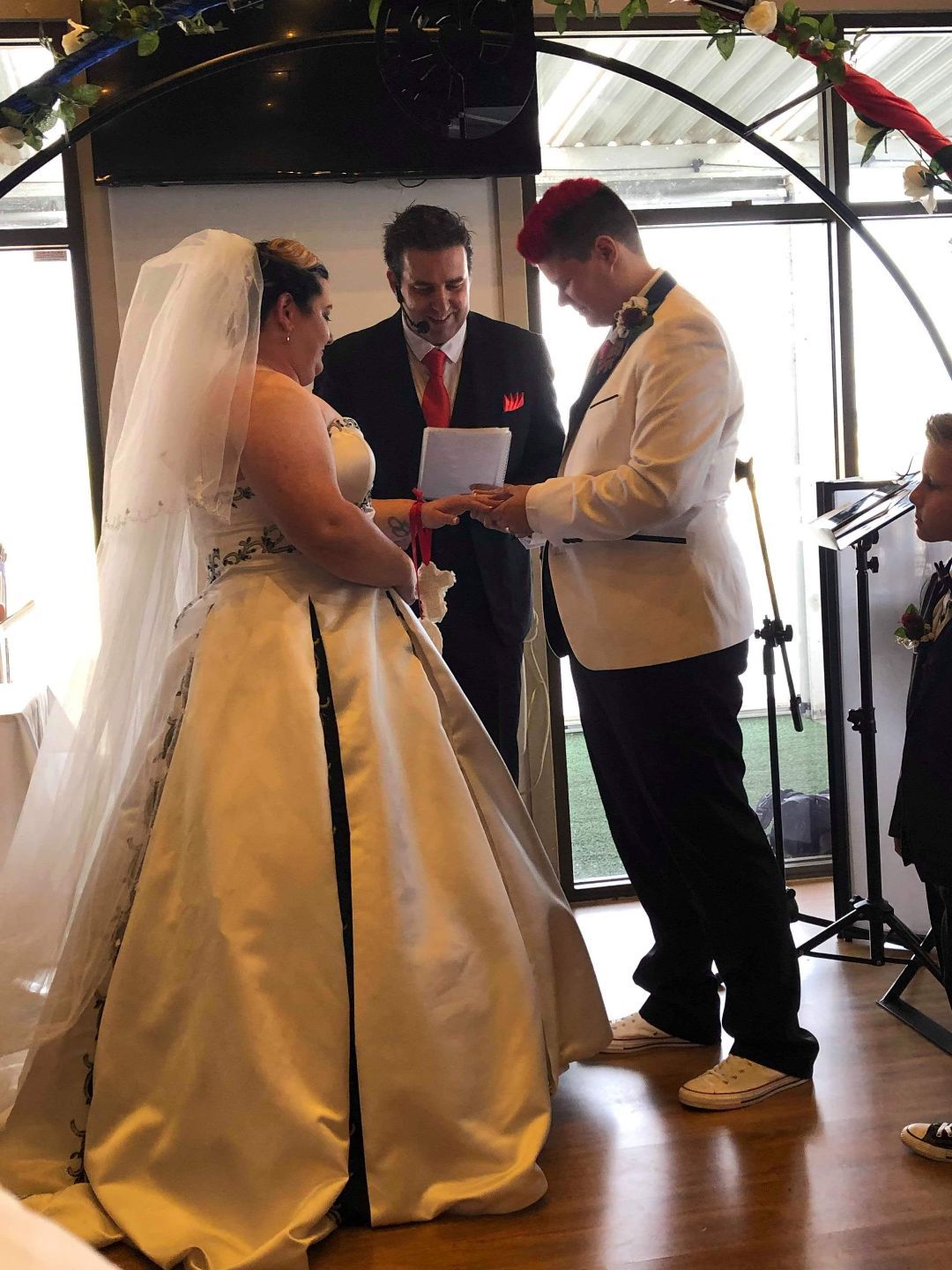 A bride and groom are getting married at a wedding ceremony
