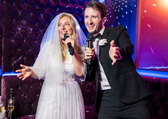 A bride and groom are laughing during their wedding ceremony.