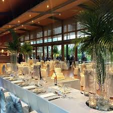 A large room with tables and chairs set up for a wedding reception.