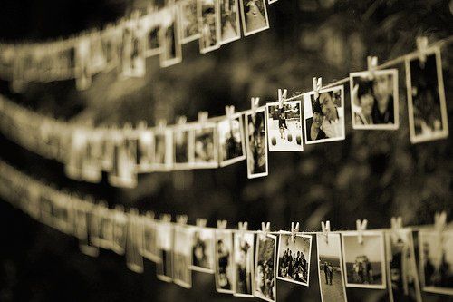 A row of pictures hanging on a clothes line