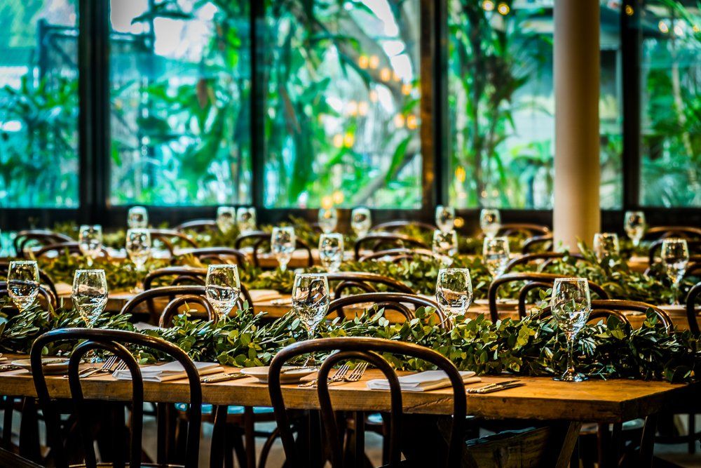 A restaurant with tables and chairs set up for a wedding reception.