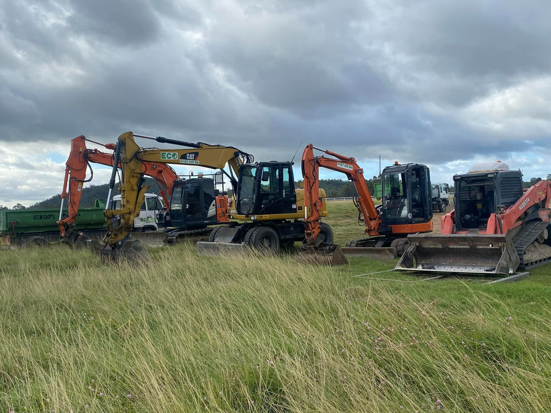 An Excavator Is Digging A Hole In The Middle Of A Road — Blue Dog Hire Qld In Airlie Beach, QLD
