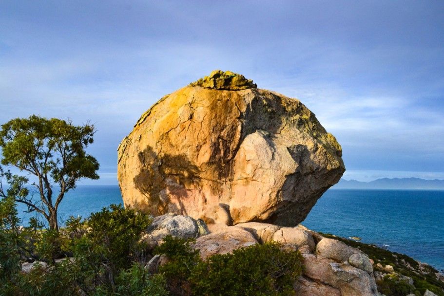 A Large Rock Sitting On Top Of A Cliff Overlooking The Ocean — Blue Dog Hire Qld In Bowen, QLD