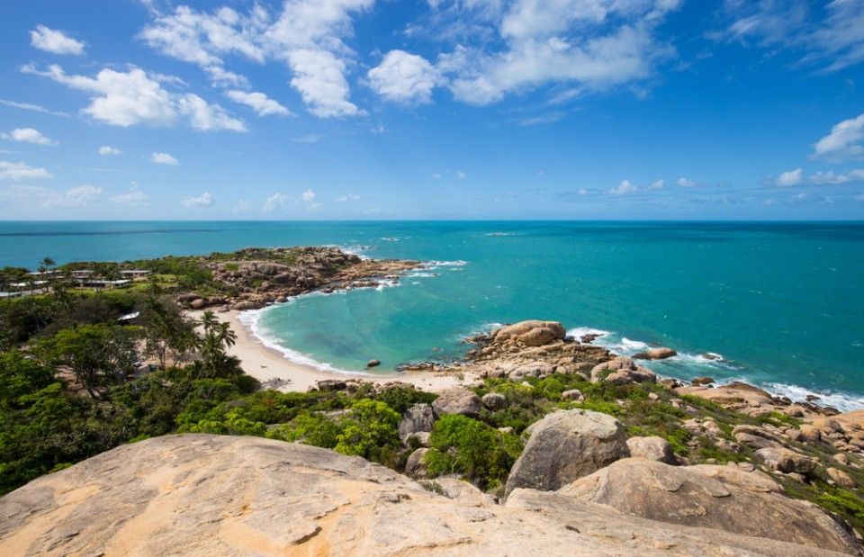 A View Of A Beach From A Rocky Cliff Overlooking The Ocean — Blue Dog Hire Qld In Bowen, QLD