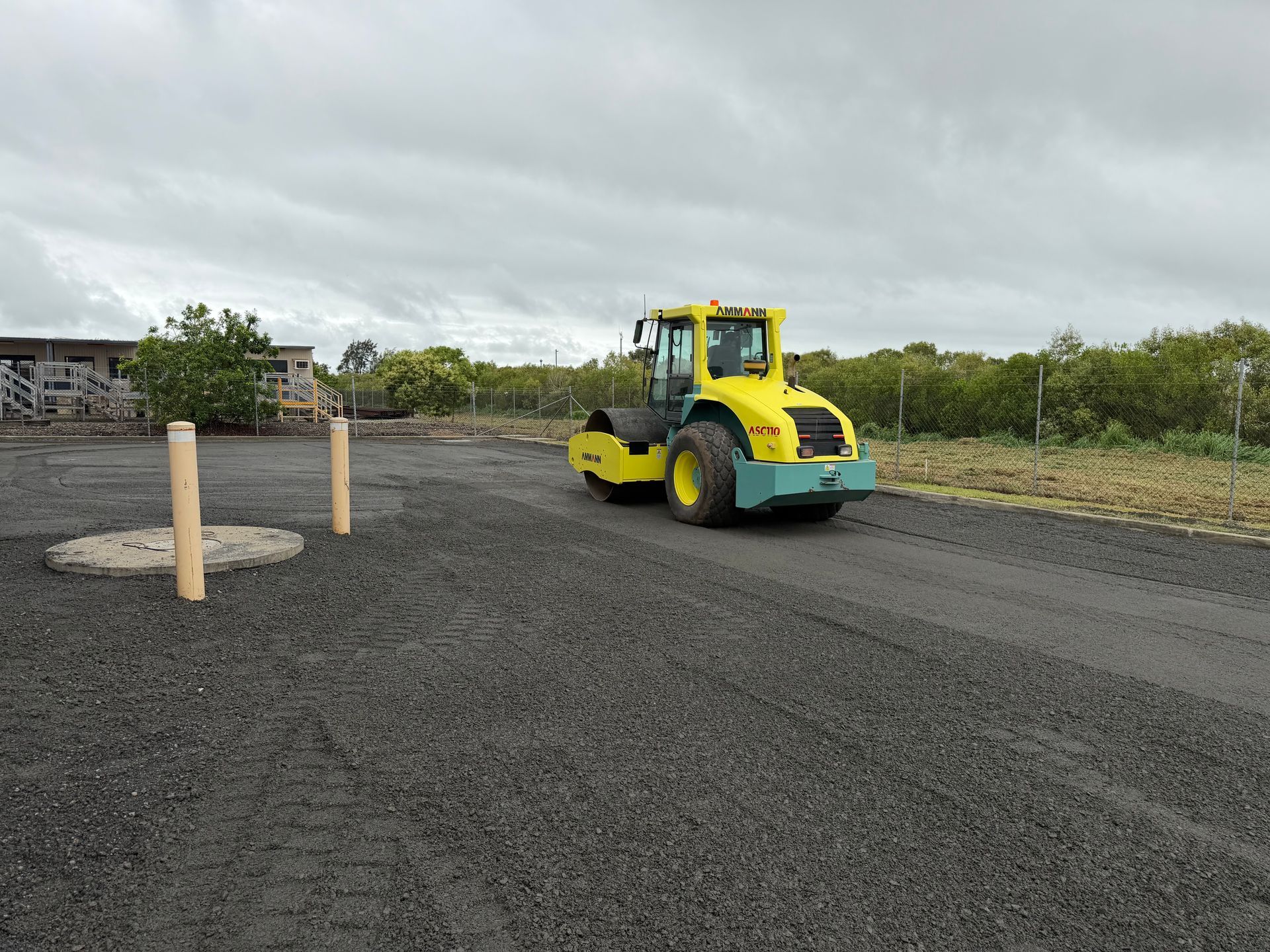 Yellow Road Roller On A Gravel Construction Site Under Cloudy Skies — Blue Dog Hire Qld In Proserpine, QLD