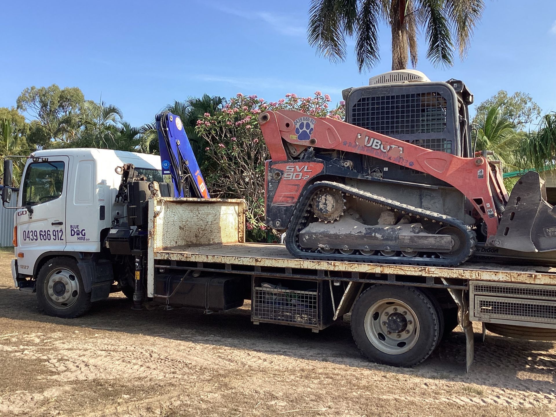 A Yellow Excavator Is Digging A Hole In The Ground — Blue Dog Hire Qld In Proserpine, QLD