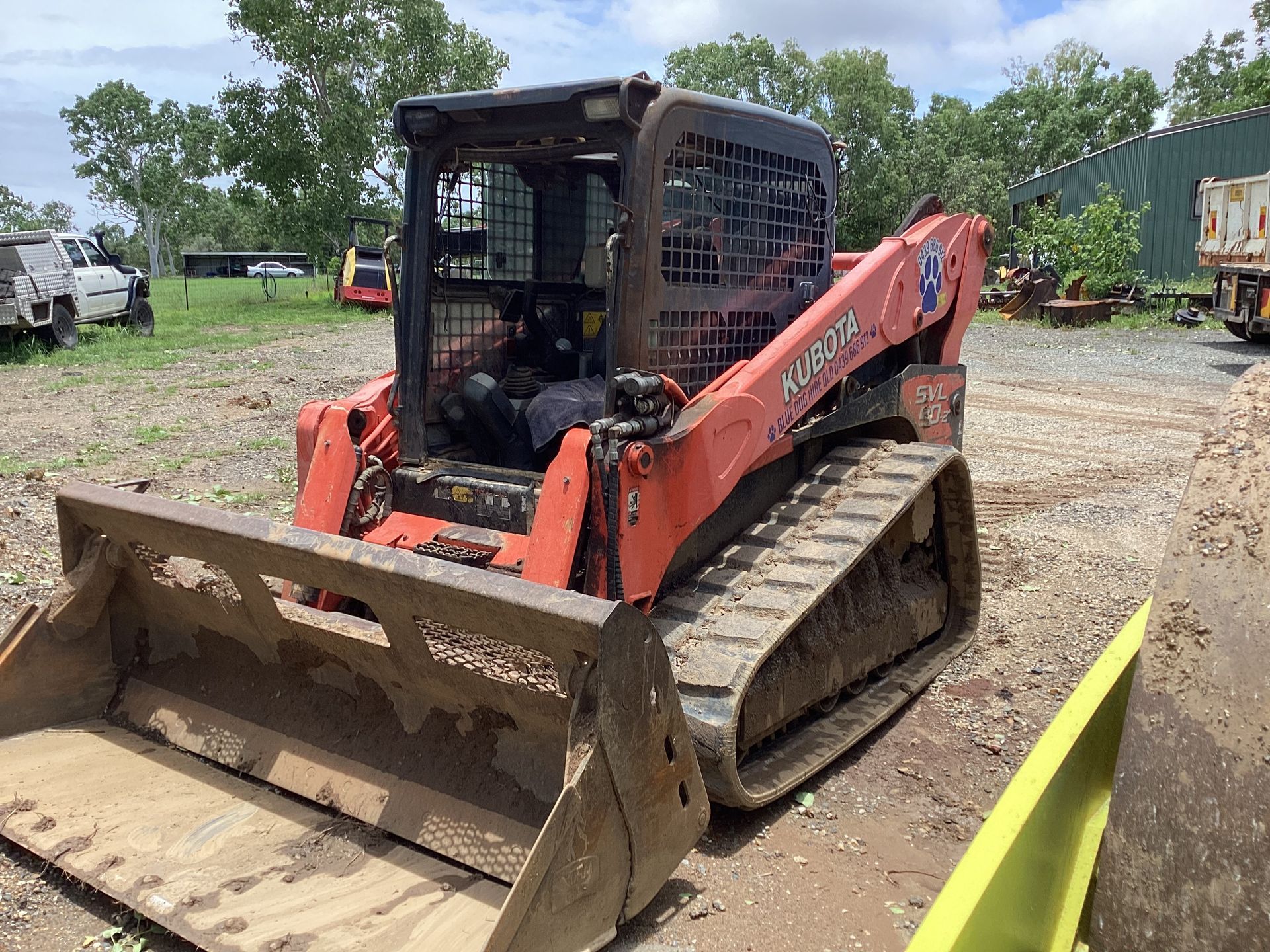 Orange Kubota track skid steer with bucket in a lot — Blue Dog Hire Qld In Midge Point, QLD