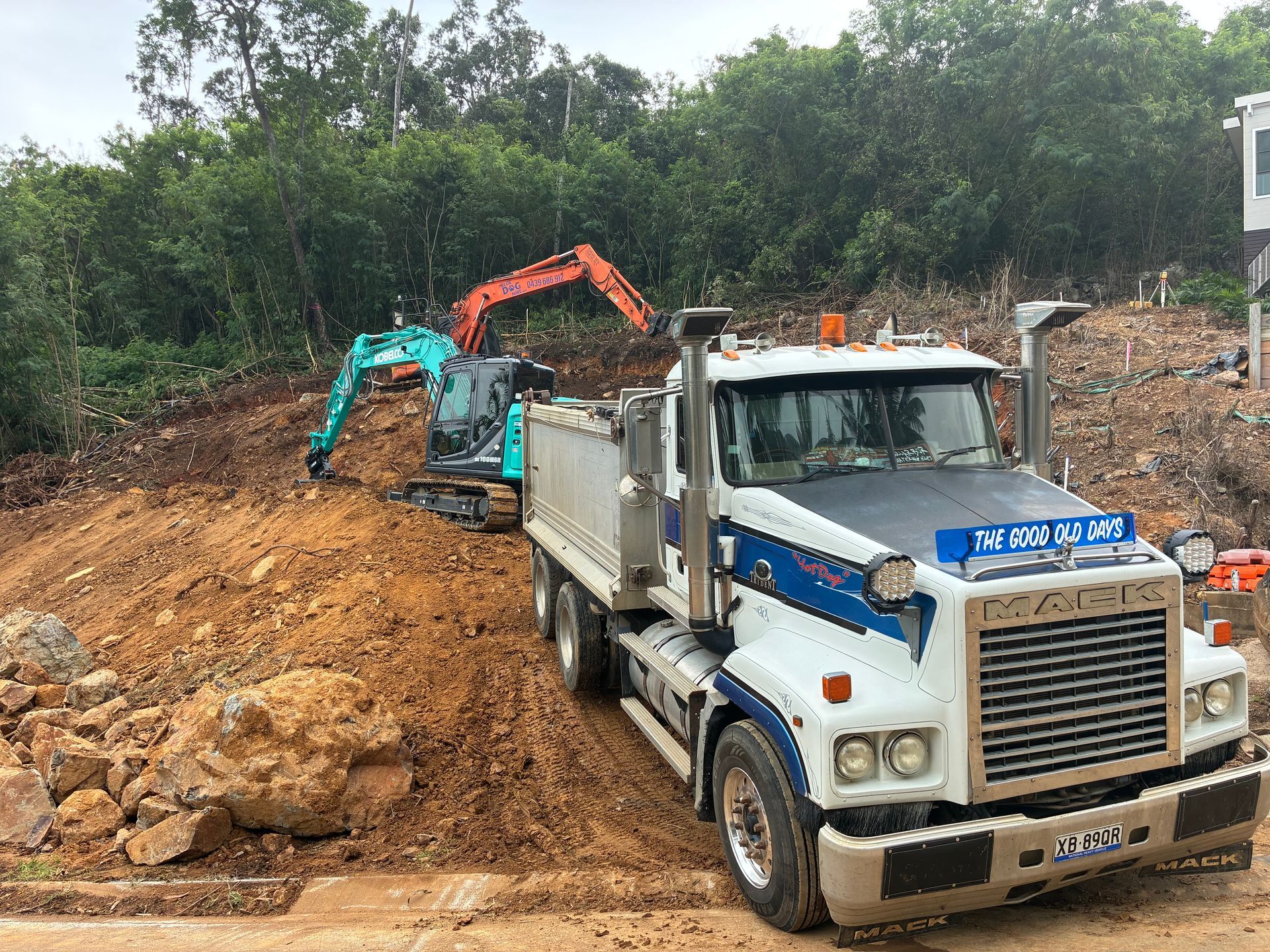White Dump Truck And Excavator Working — Blue Dog Hire Qld In Mackay, QLD