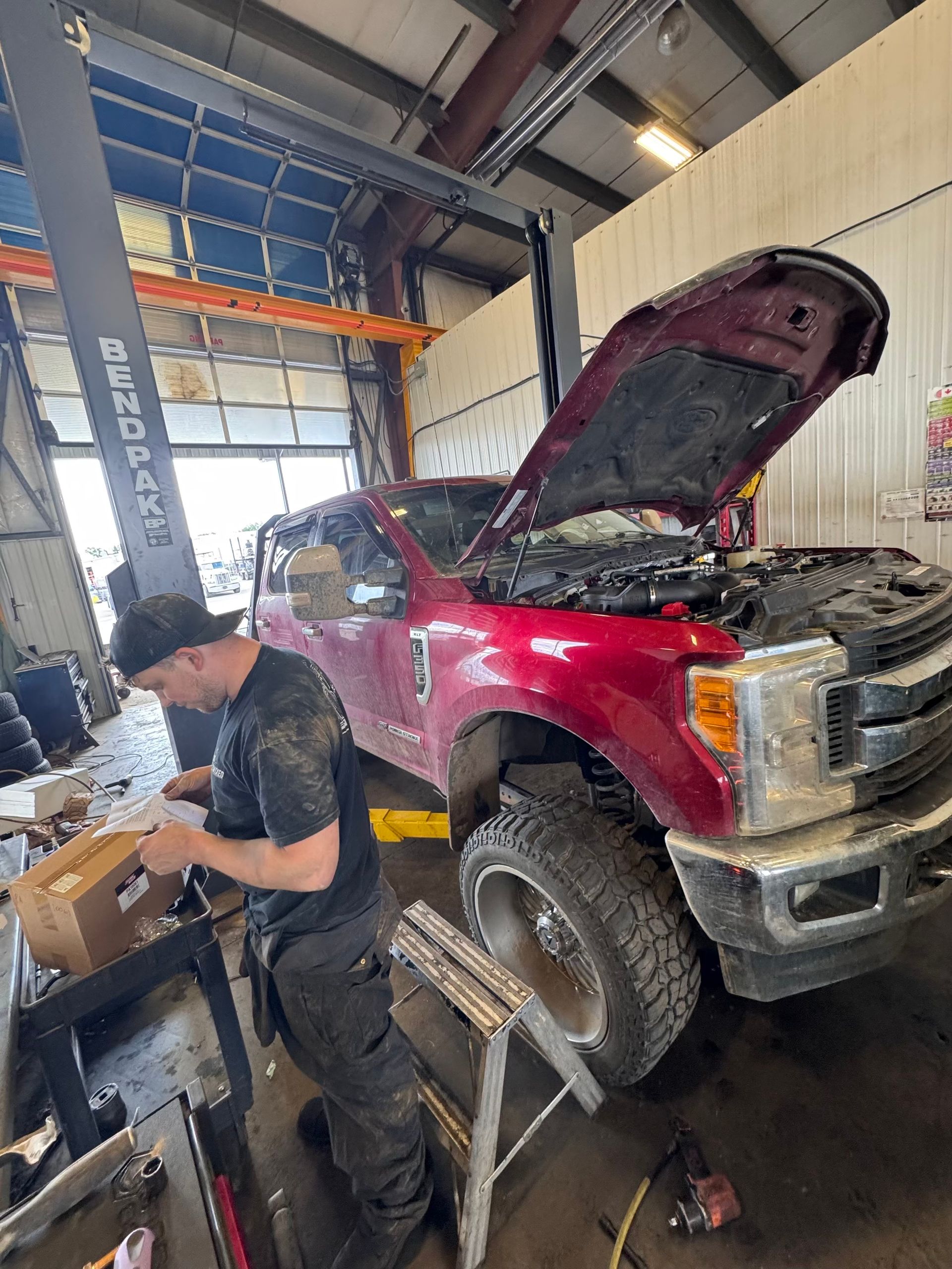 Mechanic Working On Red Ford Truck Engine | Premixed Auto & HD Repair