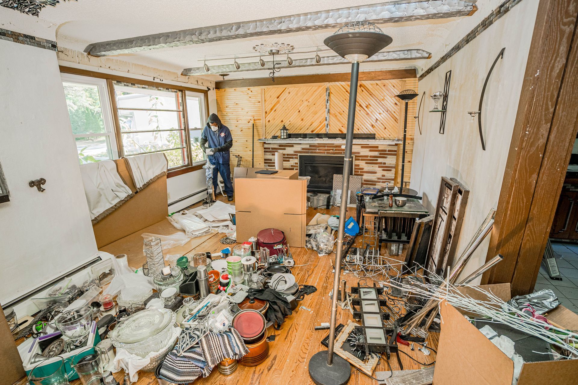 Cluttered living room with debris and boxes