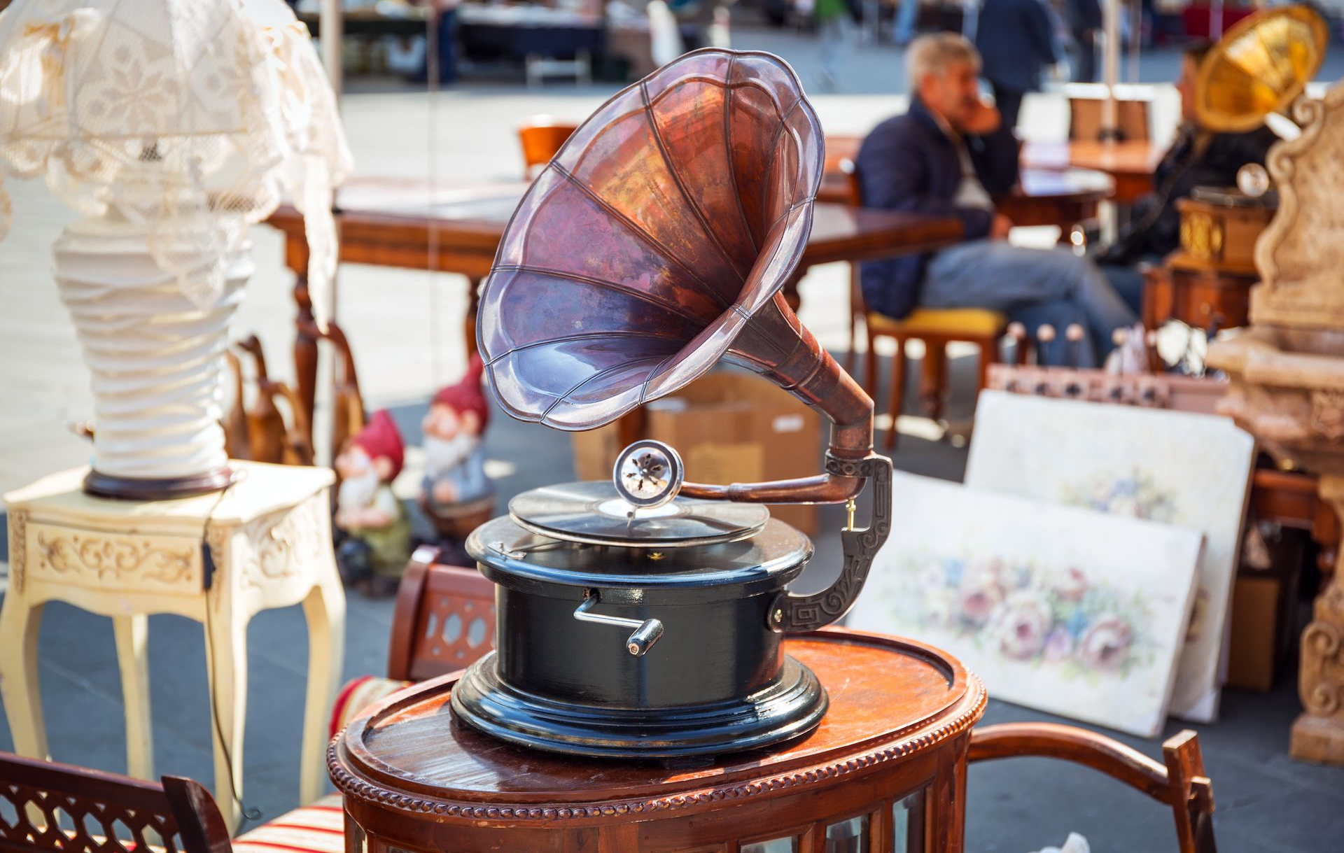 Antique gramophone with purple horn on a table at a vintage market