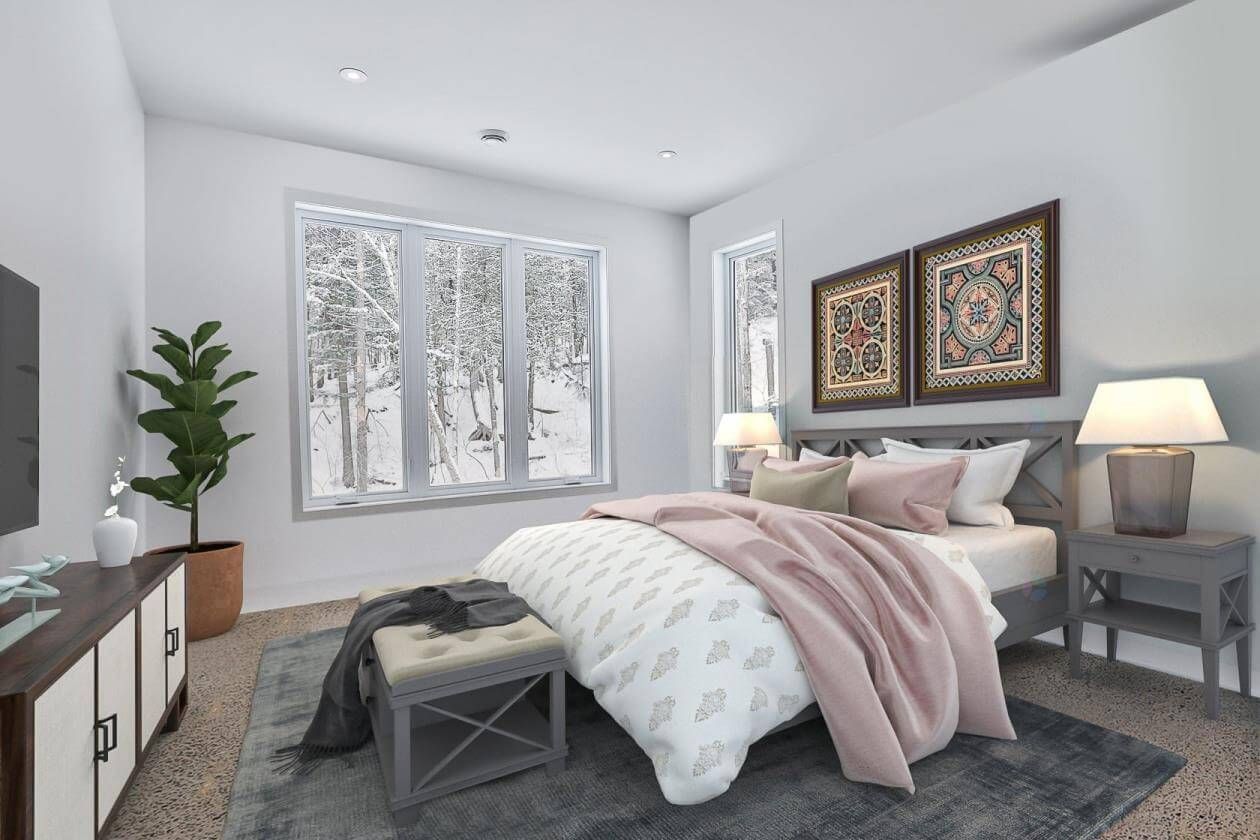 Chambre avec lit, tables de chevet et fenêtre donnant sur un paysage enneigé. Touches de rose et de gris.