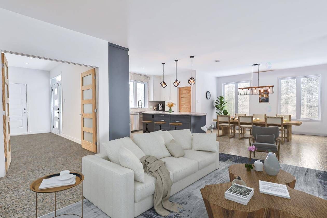 Espace de vie moderne à aire ouverte avec un canapé blanc, une table basse en bois et un coin repas en arrière-plan.