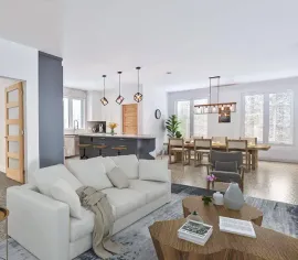 Espace de vie spacieux et moderne avec un canapé blanc, une cuisine ouverte et un coin repas.