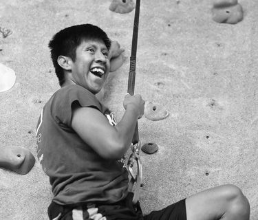 boy rock climbing