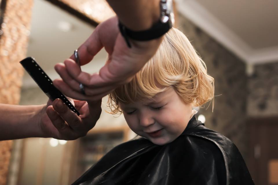 kid getting a hair cut