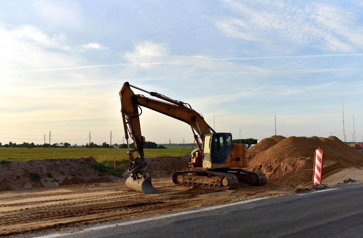 Excavator on Road Construction — Exeland, WI — A-1 Plumbing Heating & Excavating Inc.