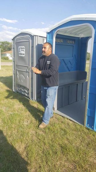 A Man is Standing Next to a Portable Toilet | Cheyenne, WY | Toilets On The Go, LLC
