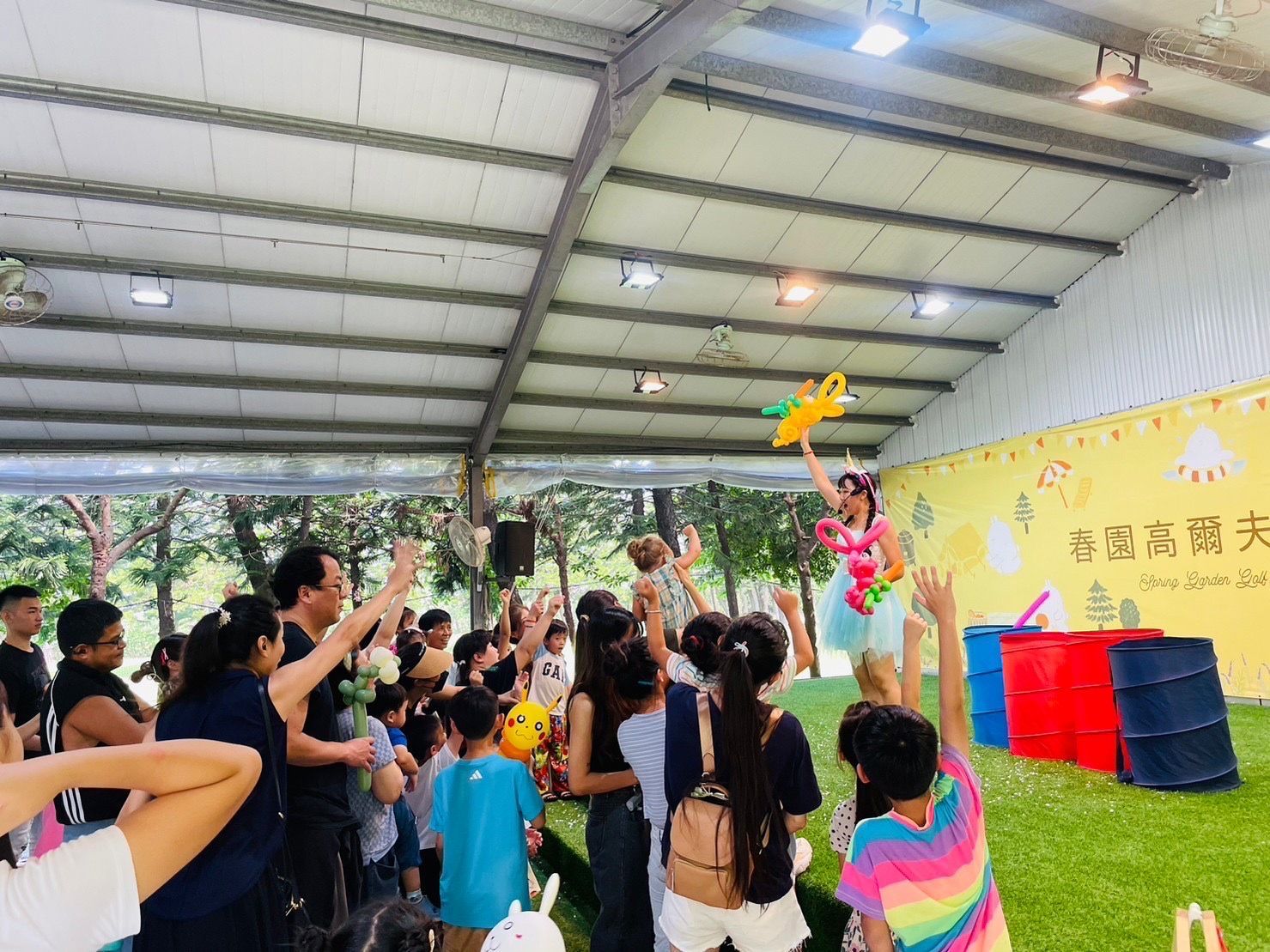 A group of people are standing in front of a stage.