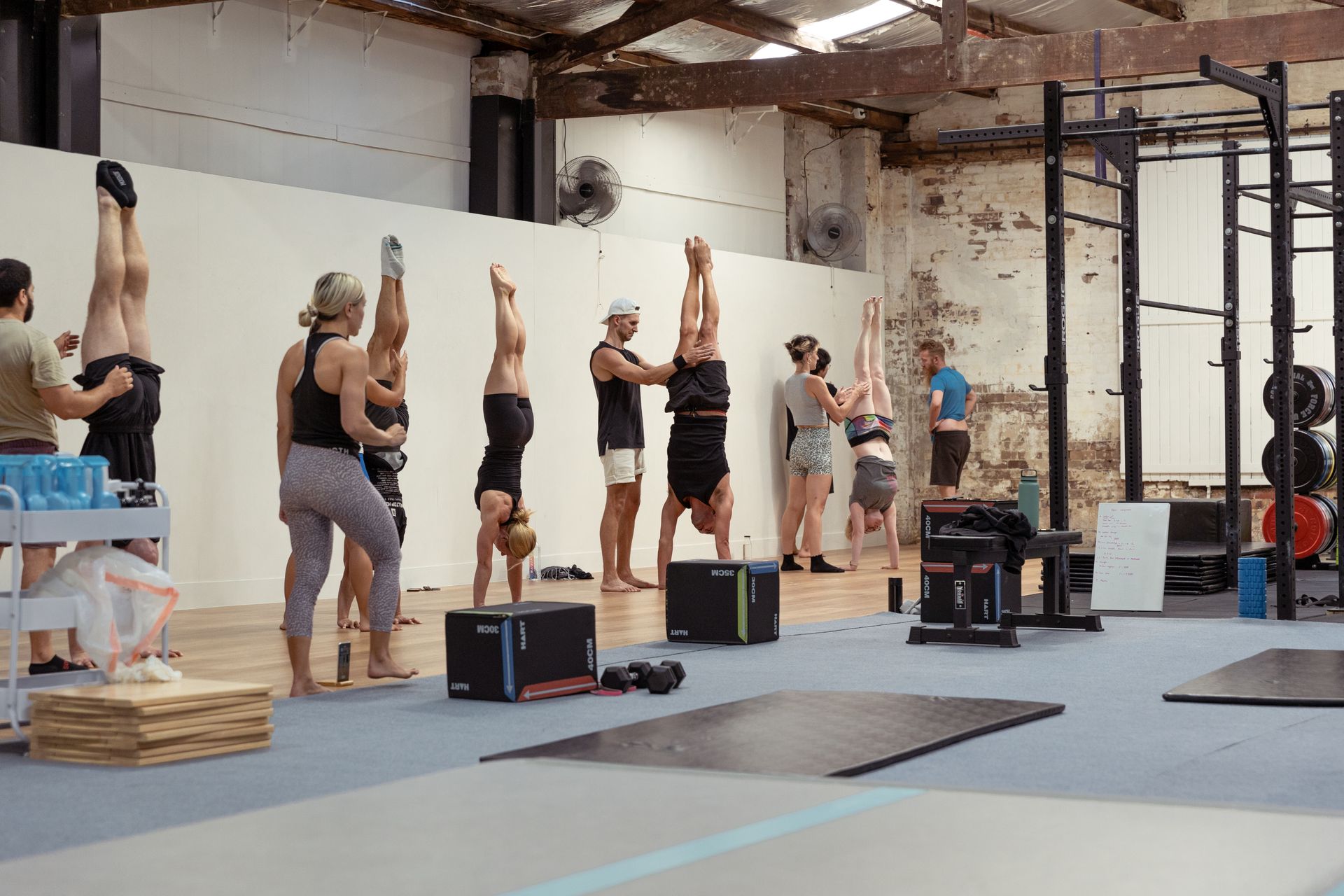 Image of people doing handstand in the gym