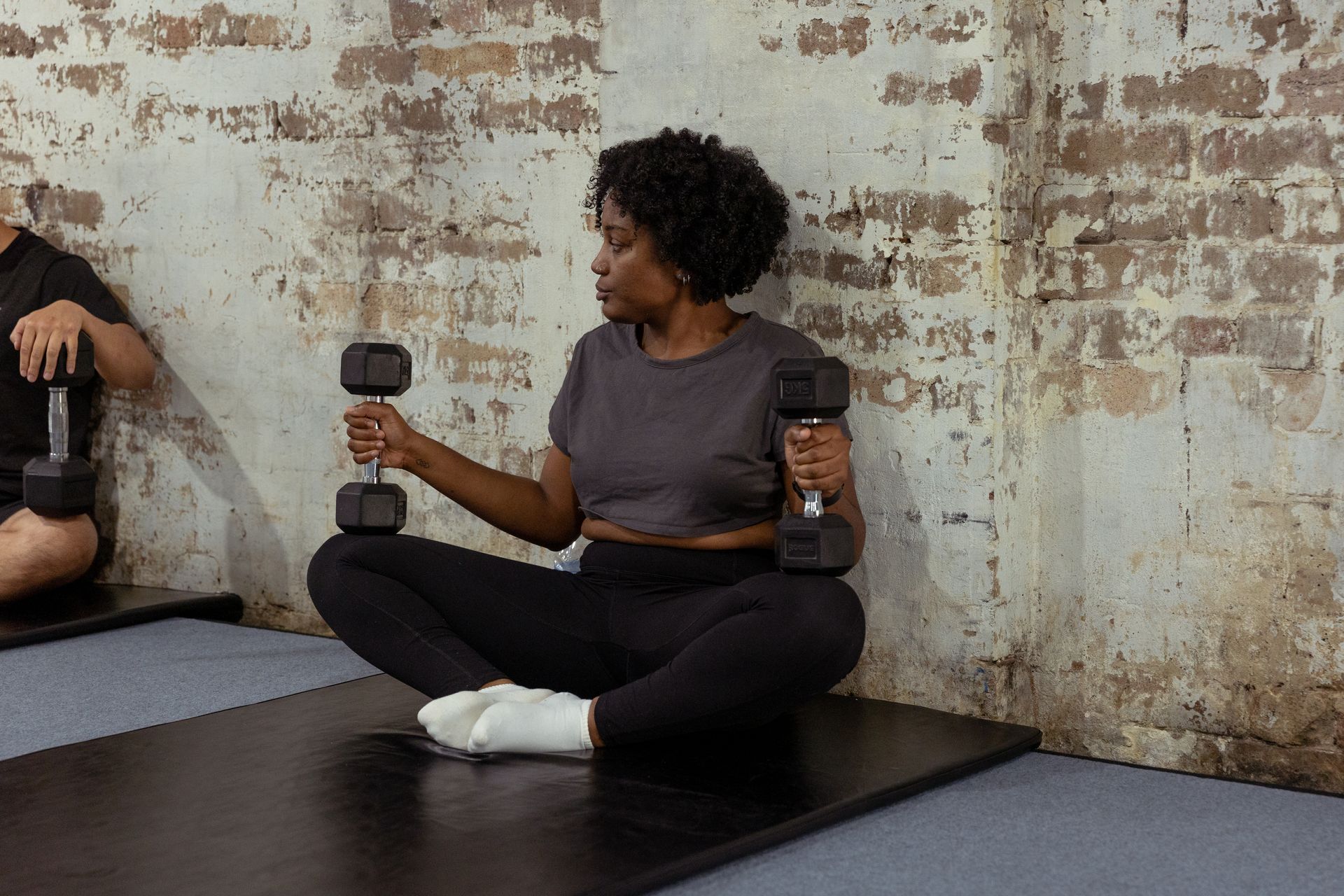 Image of a woman stretching in the gym