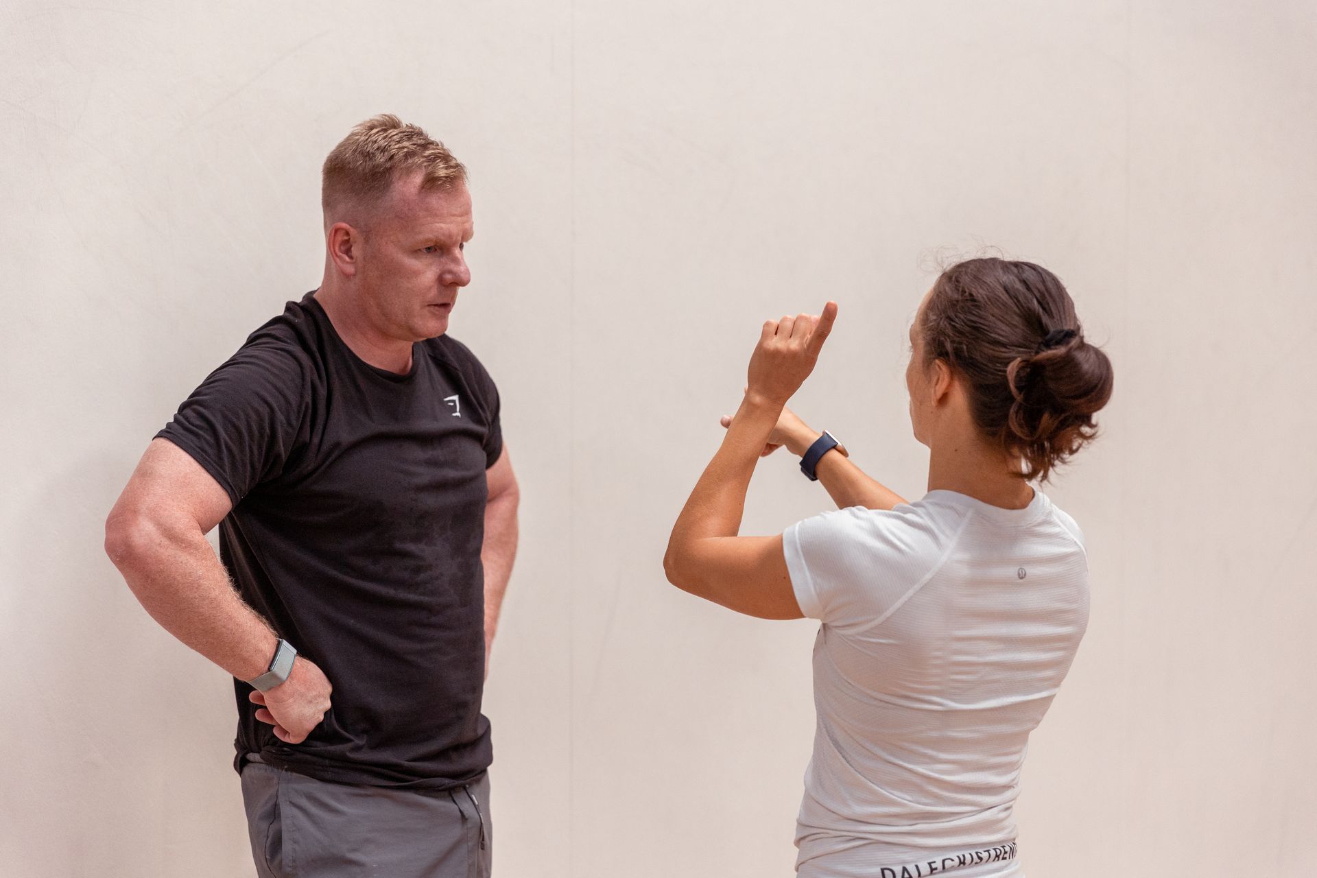 Image of a girl explaining exercise to a guy