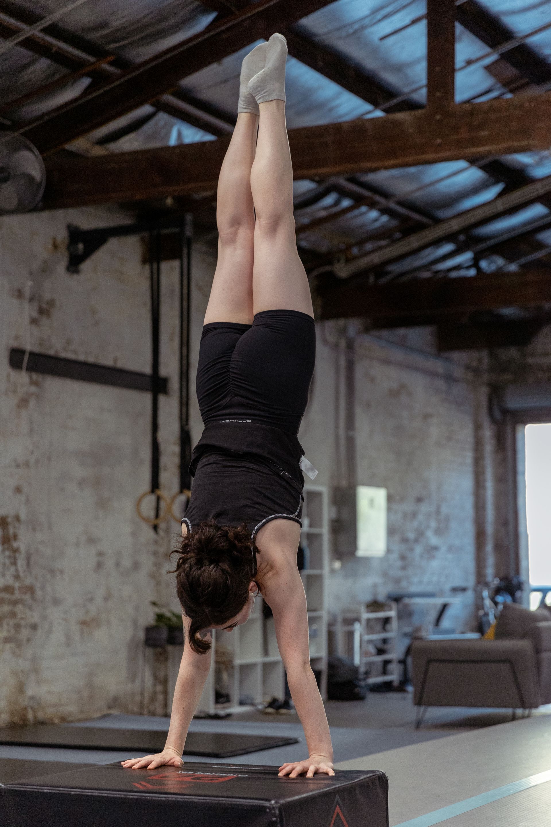 Image of a girl doing a handstand in the gym