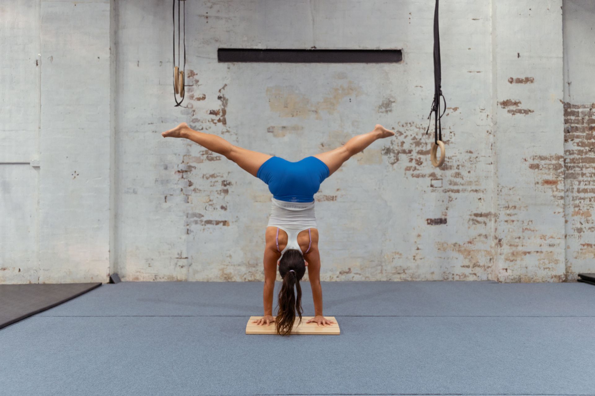Image of a girl doing a handstand in the gym