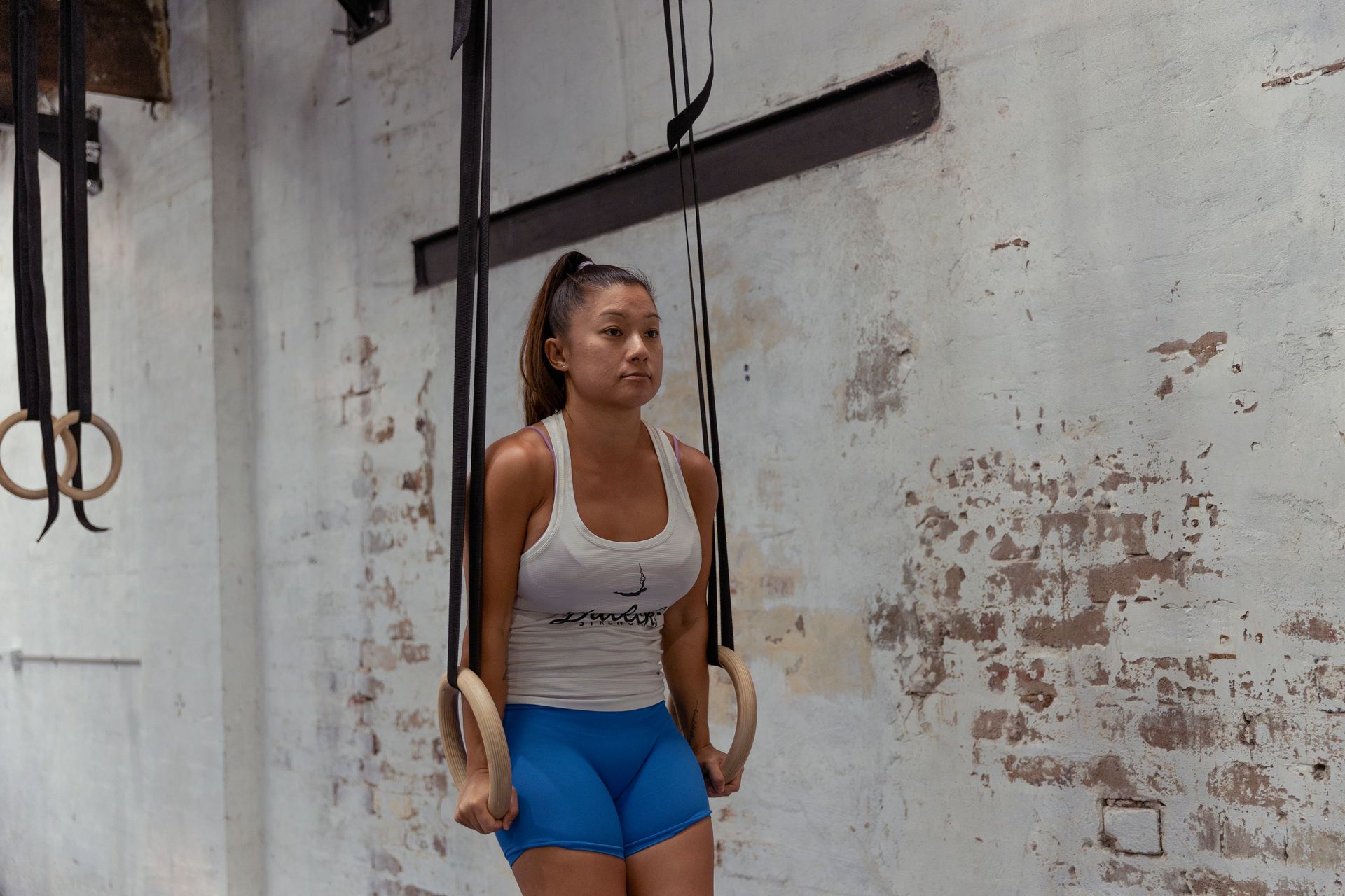 Image of a girl doing a ring pull up