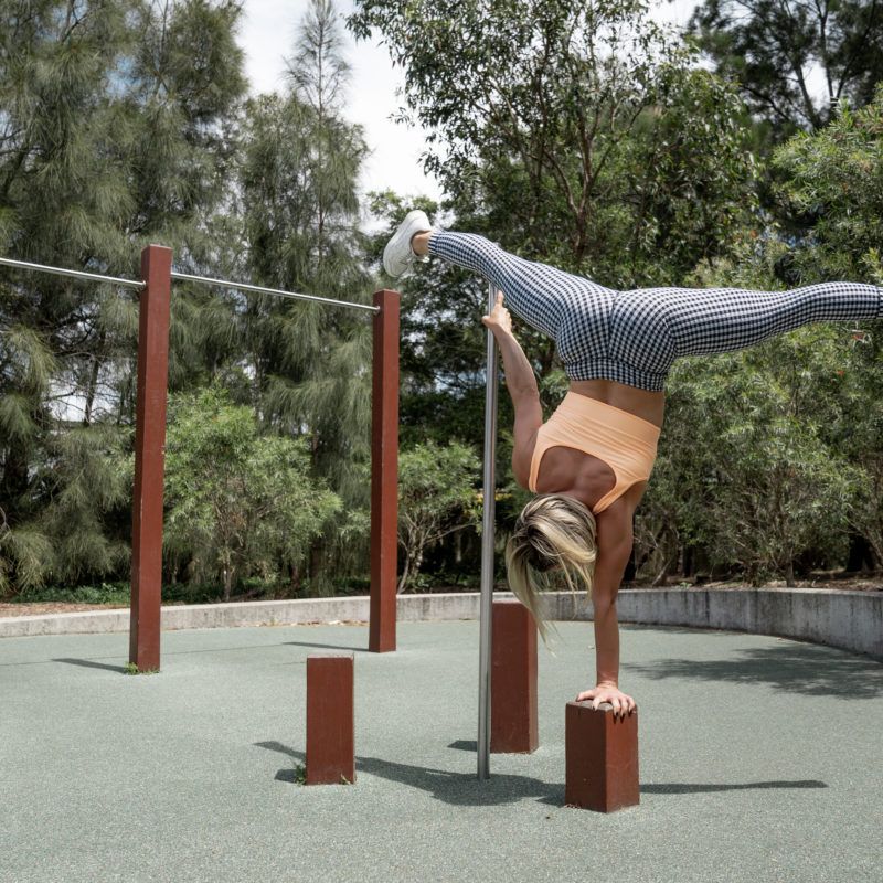 Image of a girl doing a one arm handstand