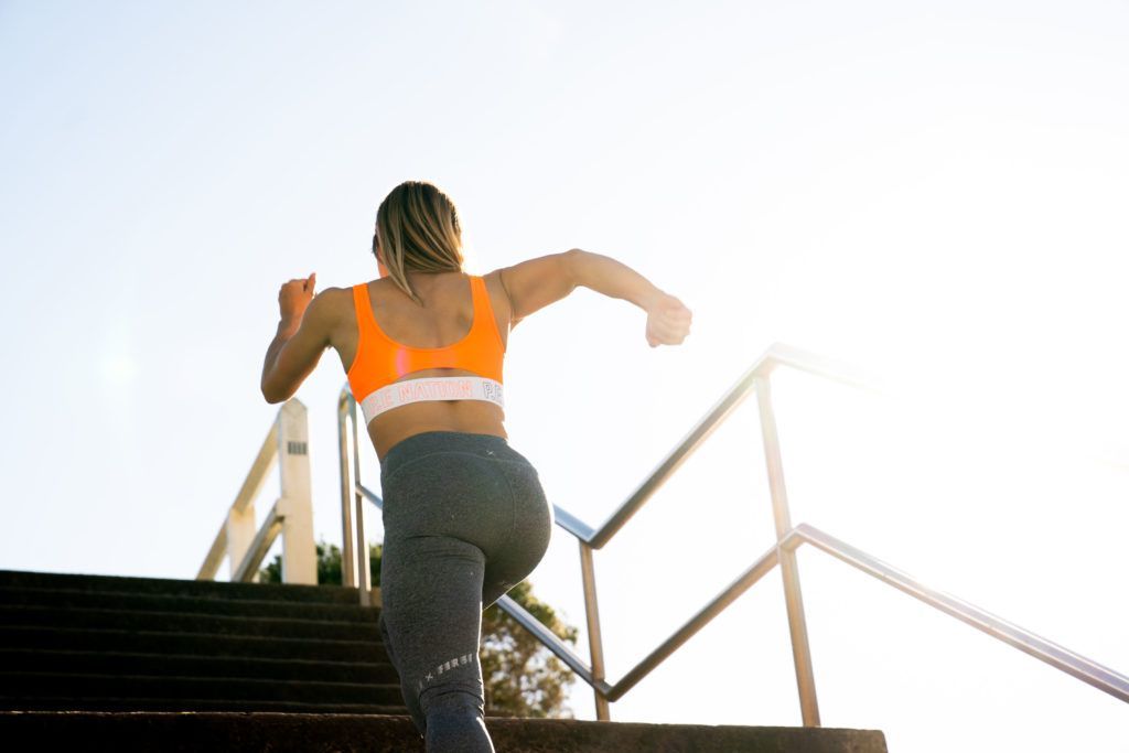 Image of a woman running up the stairs