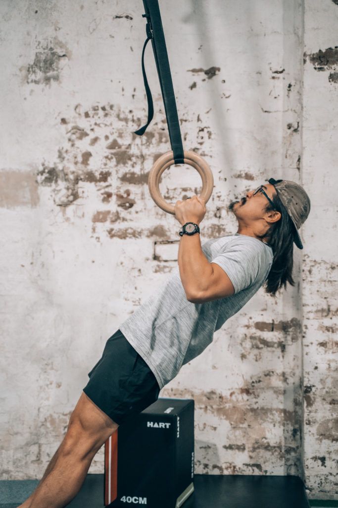 Image of a guy doing ring pull ups