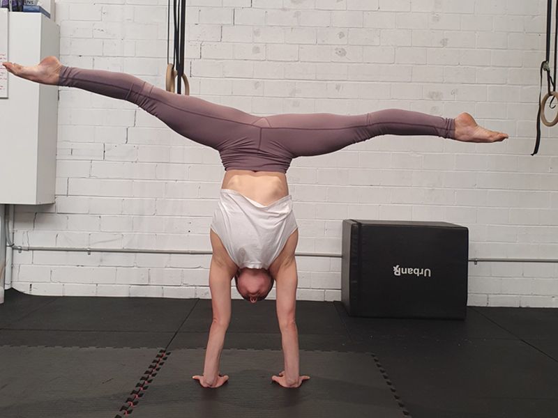 Image of a girl doing a handstand