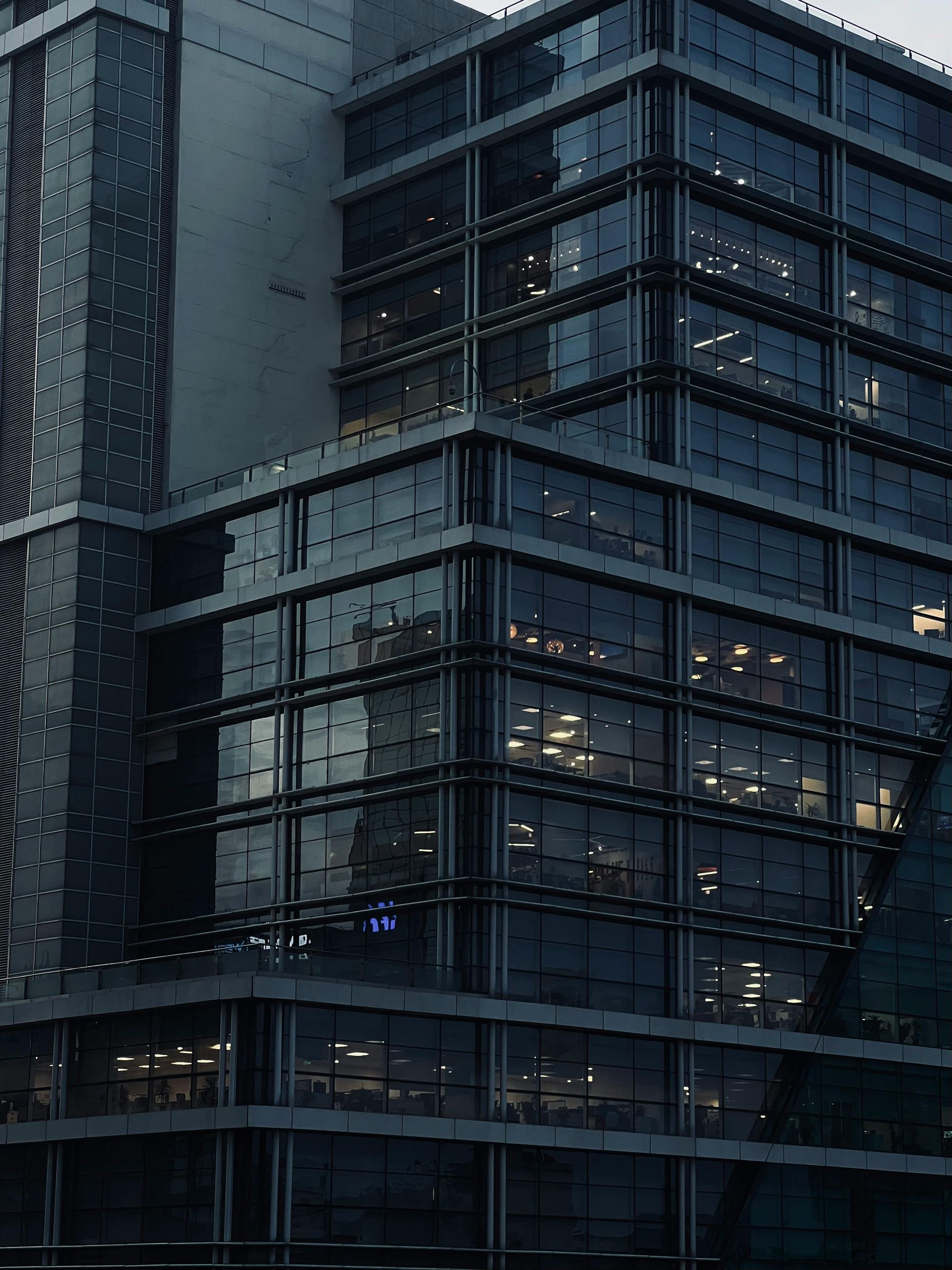 A large building with a lot of windows is lit up at night