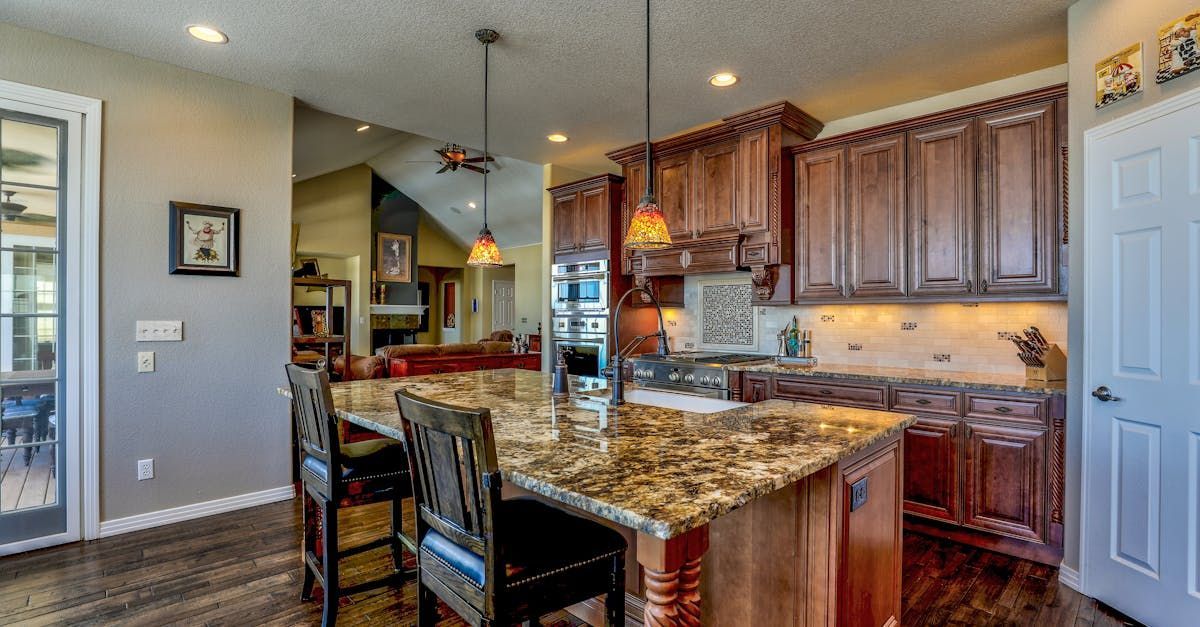 Modern kitchen showcasing dark cabinets and granite countertops for a sleek luxurious look.