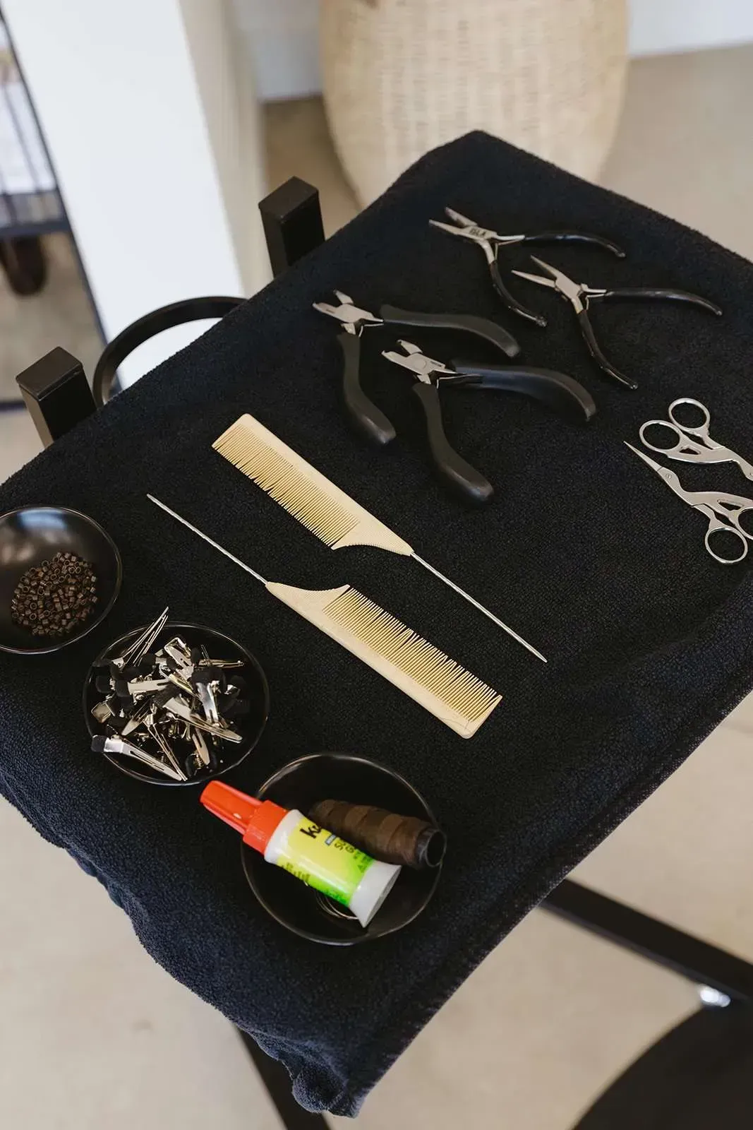 A tray with scissors combs and glue on it