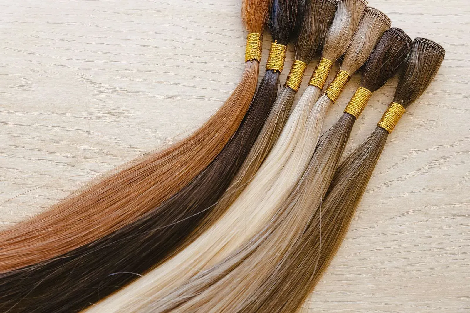 A bunch of different colored hair extensions on a table