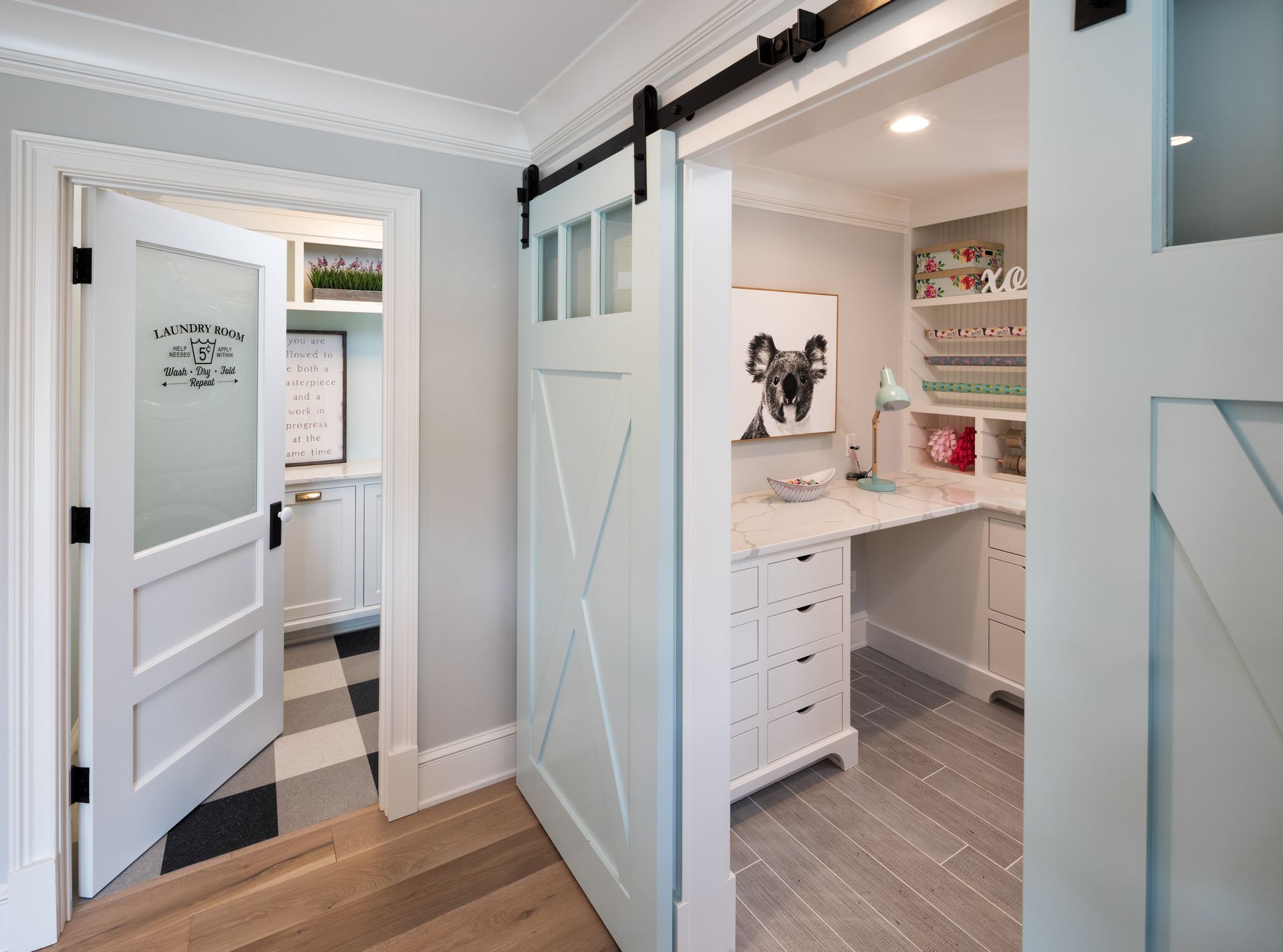 There is a sliding barn door between two rooms in a house.