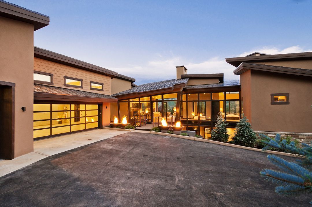 A large house with a lot of windows and a driveway