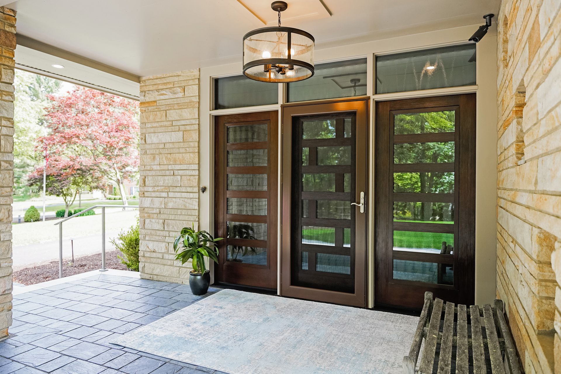 The front door of a house with a wooden bench in front of it.